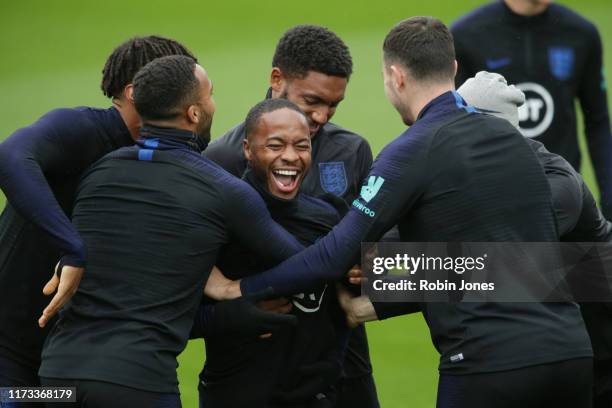 Raheem Sterling of England is trapped between Tyrone Mings, Callum Wilson, Joe Gomez and Michael Keane during a training session at Staplewood on...