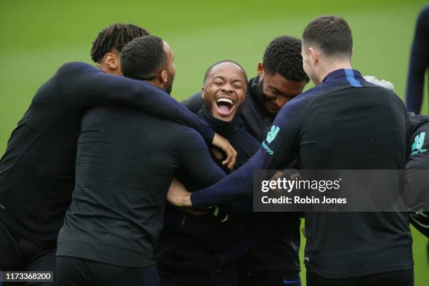 Raheem Sterling of England is trapped between Tyrone Mings, Callum Wilson, Joe Gomez and Michael Keane during a training session at Staplewood on...