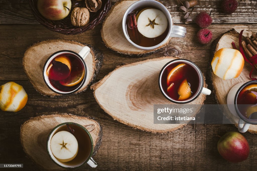 Hot drinks in rural mugs on cross-section of tree