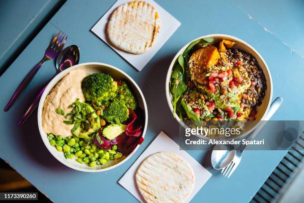 vegan bowls with various vegetables and seeds, high angle view - tipo di cibo foto e immagini stock