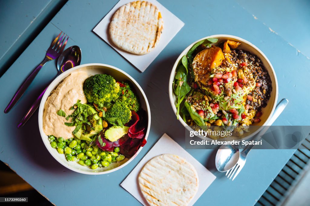 Vegan bowls with various vegetables and seeds, high angle view