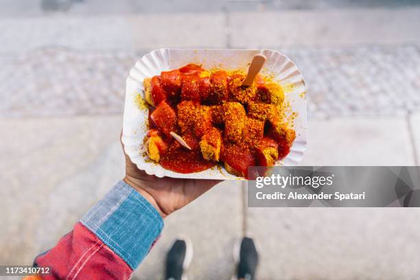 eating currywurst from personal perspective point of view - currywurst stock-fotos und bilder