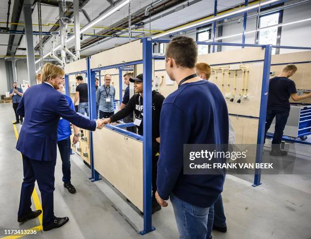 King Willem-Alexander of the Netherlands shakes hands with employees of Klein Metaal Werken Eindhoven during a visit of the Brainport Industries...