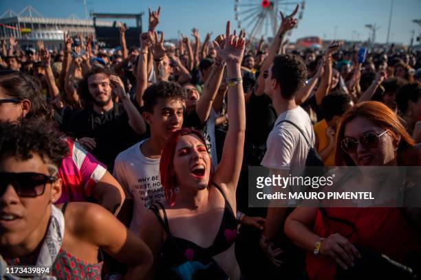 Fans enjoy the joint-performance of the Colombian band 'Monsieur Perine' and the Brazilian band 'Francisco, El Hombre' during the Rock in Rio...
