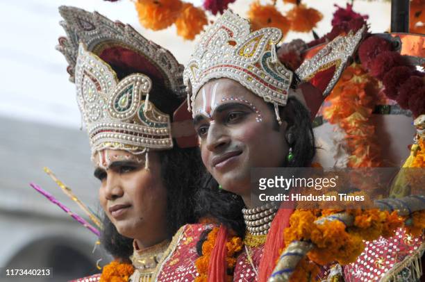 Artists dressed as Hindu Gods Ram and Bharat from Ramayana during a religious procession ahead of the Dussehra Festival, on October 3, 2019 in Noida,...