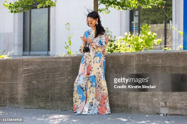 Digital influencer Pornwika Spiecker wears Gucci sunglasses Munthe dress, Jacquemus bag and Bottega Veneta shoes on July 03, 2019 in Paris, France.