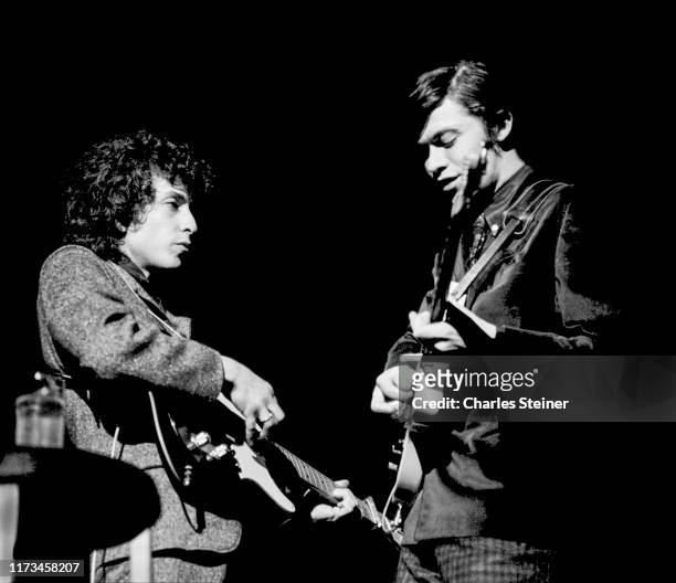 An image of Bob Dylan and Robbie Robertson playing electric guitars during Dylan's 2nd set at the Academy of Music on February 24, 1966.