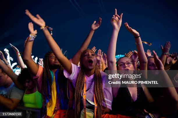 Fans of Brazilian rock band Capital Inicial enjoy their performance during the Rock in Rio festival at the Olympic Park in Rio de Janeiro, Brazil, on...