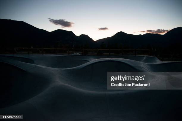 skatepark transitions in the rocky mountains at dusk - adrenaline park stock pictures, royalty-free photos & images