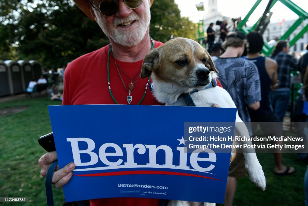 Bernie Rally Live Denver Hinton Harrison and his dog Pee Wee hold up a sign in support of ...