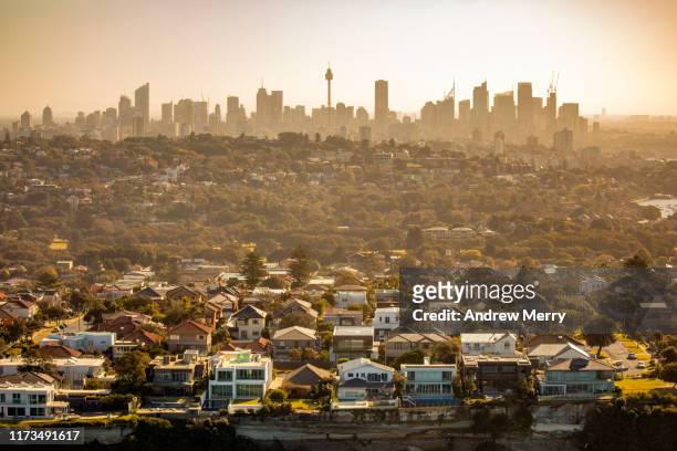 aerial photography of sydney skyline cityscape, suburb and houses on costal sea cliff, australia - australien stock-fotos und bilder