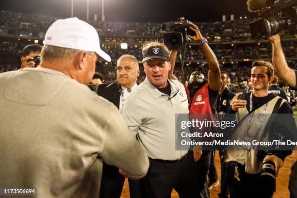 Head coach Jon Gruden of the Oakland Raiders and head coach Vic Fangio of the Denver Broncos shake hands after the second half of the Raiders' 24-16...