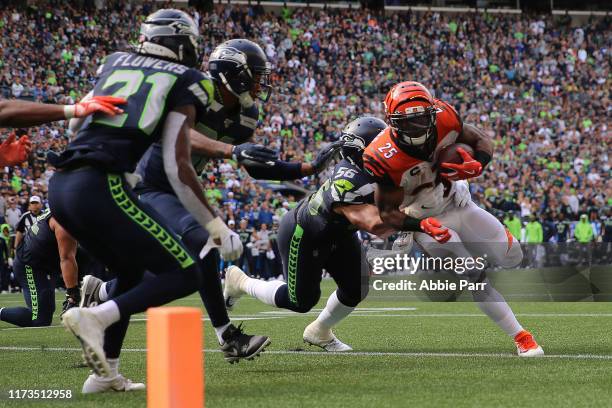 Giovani Bernard of the Cincinnati Bengals runs with the ball against Mychal Kendricks of the Seattle Seahawks in the fourth quarter during their game...