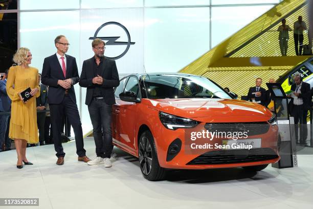 Michael Lohscheller, CEO of Opel, and Juergen Klopp, Manager of FC Liverpool, present the Opel Corsa E electric car at the 2019 IAA Frankfurt Auto...