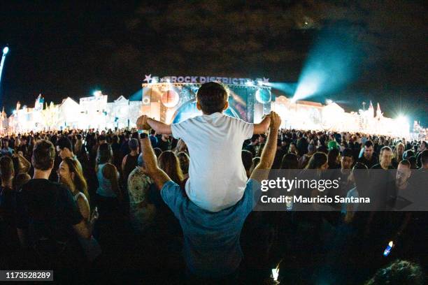 Children at fathers shoulder during day 4 of Rock In Rio Music Festival at Cidade do Rock on October 3, 2019 in Rio de Janeiro, Brazil.