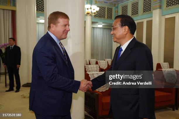 Chinese Premier Li Keqiang shakes hands with Executive Vice President and Head of International Affairs at the U.S. Chamber of Commerce Myron...