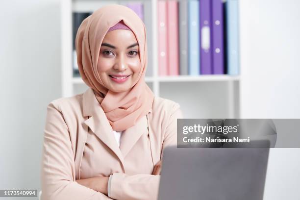 attractive and beautiful muslim businesswoman working in office. - malaysian people stock pictures, royalty-free photos & images
