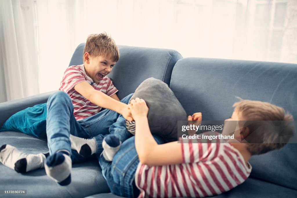 Twin boys fighting at home