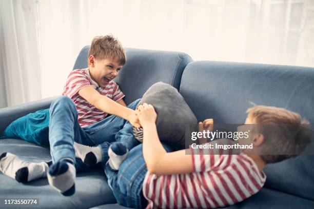 twin boys fighting at home - brother stock pictures, royalty-free photos & images