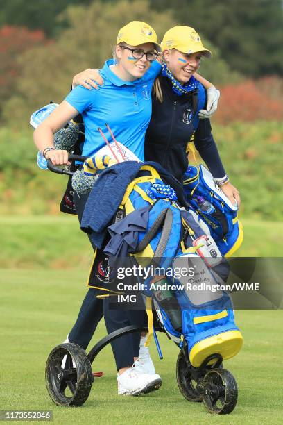 Hannah Darling and Annabell Fuller of Team Europe embrace as they walk off the 14th tee during the PING Junior Solheim Cup during practice day 2 for...