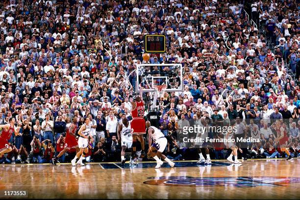 Michael Jordan of the Chicago Bulls shoots the game winner over Byron Russell of the Utah Jazz during Game six of the 1998 NBA Finals that gave the...