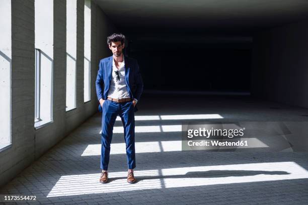portrait of confident businessman standing in a passageway - elegant handsome beard man foto e immagini stock