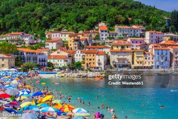people enjoying at beach by opatija town during summer - kroatien strand stock pictures, royalty-free photos & images