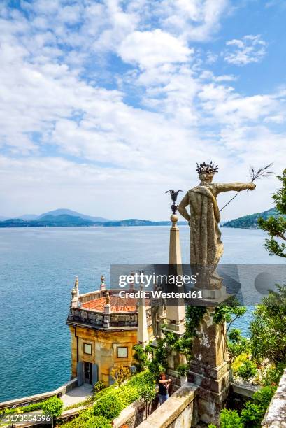 statue at isola bella by lake maggiore against sky - isola bella stock-fotos und bilder