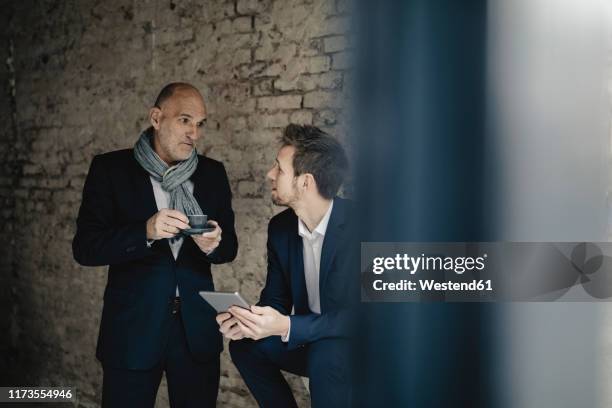 senior and mid-adult businessman having a meeting - father son business europe stock pictures, royalty-free photos & images