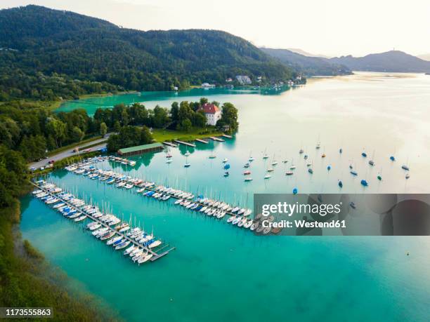 aerial view of boats moored by jetty in woerthersee at harbor against sky during sunset - kärnten am wörthersee stock pictures, royalty-free photos & images