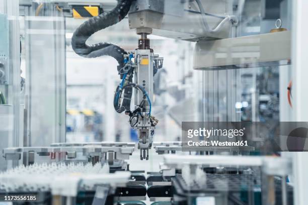 arm of assembly robot functioning inside modern factory, stuttgart, germany - factory stock-fotos und bilder