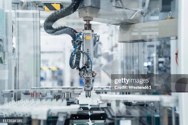 arm of assembly robot functioning inside modern factory, stuttgart, germany - ロボット ストックフォトと画像