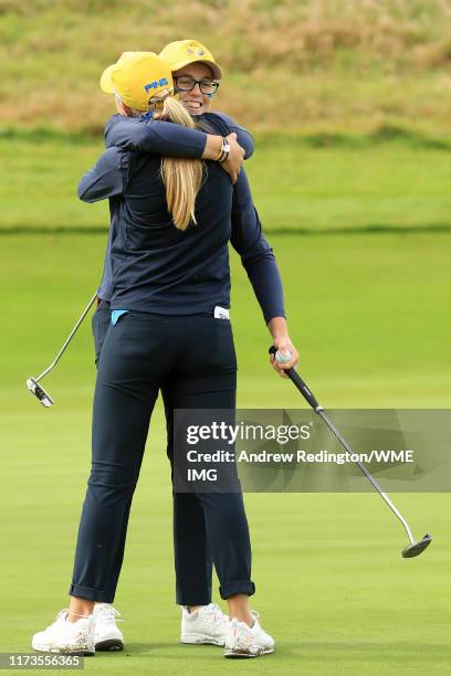 Hannah Darling and Annabell Fuller of Team Europe embrace after winning the match on the 15th green during the PING Junior Solheim Cup during...