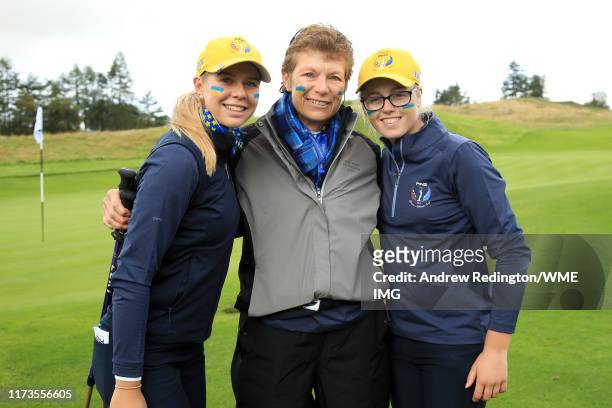 Hannah Darling and Annabell Fuller of Team Europe pose for a photograph with Captain Mickey Walker after winning the match on the 15th green during...