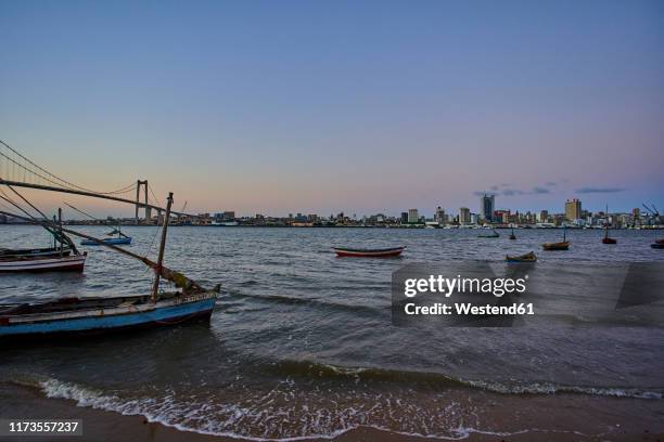small boats with view to the skyline of maputo, catembe, mozambique - maputo mozambique city imagens e fotografias de stock