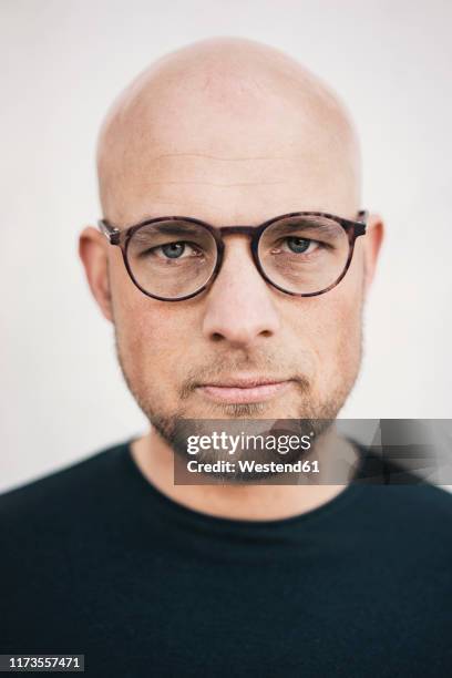 portrait of serious bald man with beard wearing glasses - bald man foto e immagini stock