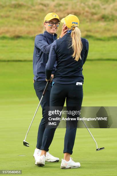 Hannah Darling and Annabell Fuller of Team Europe embrace after winning the match on the 15th green during the PING Junior Solheim Cup during...