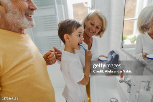 brushing teeth properly - old man brushing teeth stock pictures, royalty-free photos & images