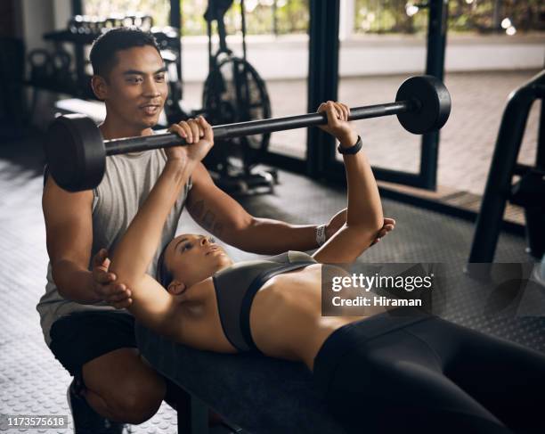 Chest press workout. Young woman exercising in gym Stock Photo - Alamy