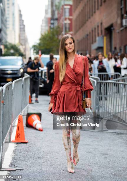 Nina Agdal is seen wearing wrapped dress, overknees boots with floral print outside Zimmermann during New York Fashion Week September 2019 on...