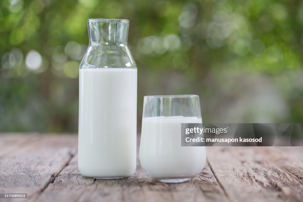 Milk bottle and milk glass on wooden table