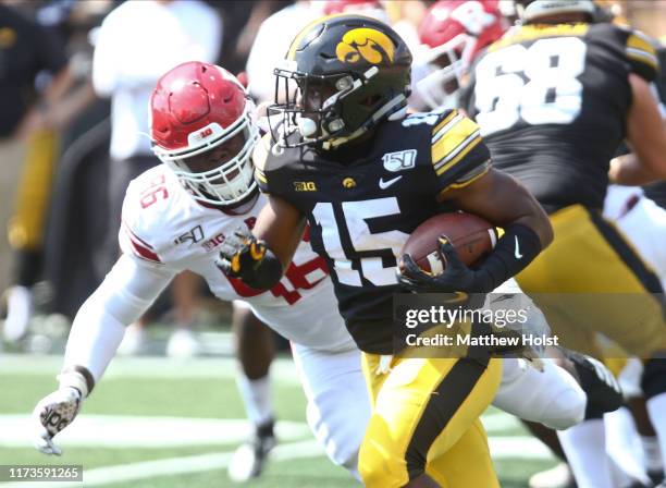 Running back Tyler Goodson of the Iowa Hawkeyes rushes up field during the second half against defensive lineman Willington Previlon of the Rutgers...