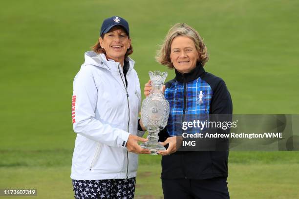 Team USA Captain Juli Inkster and Team Europe Captain Catriona Matthew pose with the Solheim Cup Trophy during the Official team photo call during...