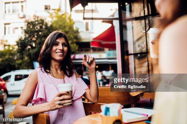 middle eastern girls having coffee and talking - turkey middle east stock pictures, royalty-free photos & images