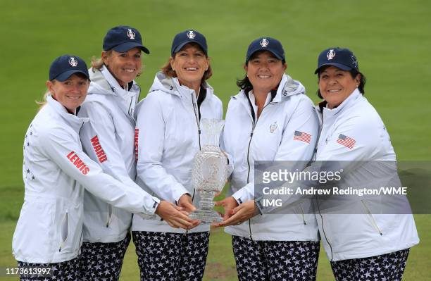 Stacy Lewis, Wendy Ward, Juli Inkster, Pat Hurst and Nancy Lopez pose with the Solheim Cup Trophy during the official photocall during practice day 2...