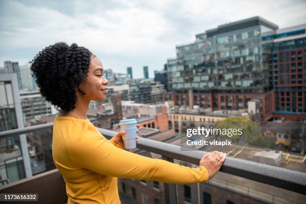 woman holding a reusable cup - toronto condo stock pictures, royalty-free photos & images