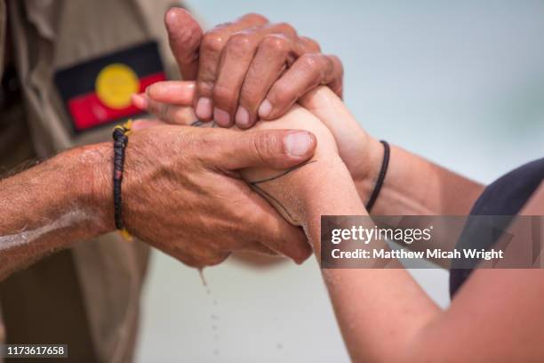 an aboriginal cultural ceremony involving hand painting. - indigenous australians stock-fotos und bilder