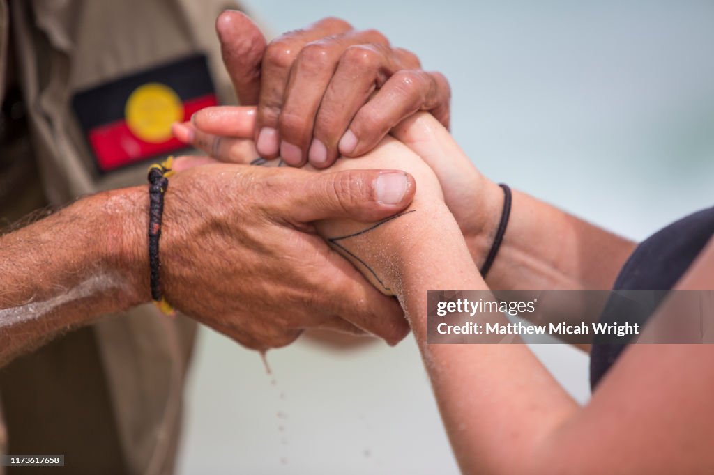 An aboriginal cultural ceremony involving hand painting.