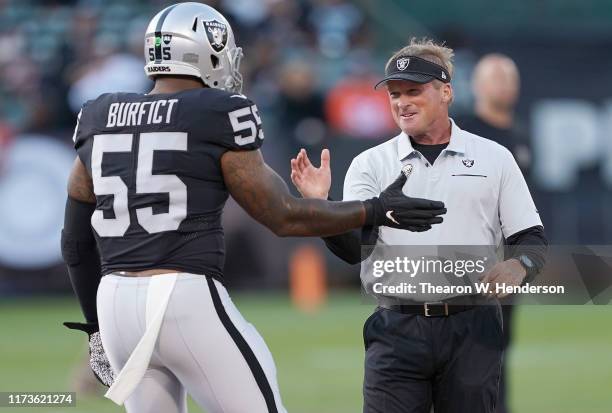 Head coach Jon Gruden of the Oakland Raiders greets outside linebacker Vontaze Burfict prior to their game against the Denver Broncos at RingCentral...