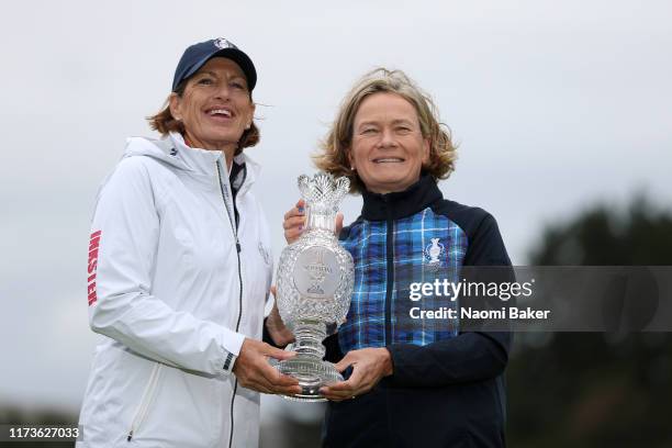 Team USA Captain Juli Inkster and Team Europe Captain Catriona Matthew pose with the Solheim Cup Trophy during the Official team photo call during...